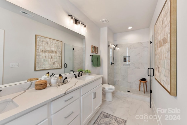 bathroom featuring vanity, toilet, and a shower with shower door