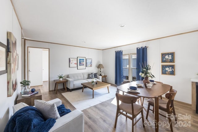 interior space with light hardwood / wood-style floors and crown molding