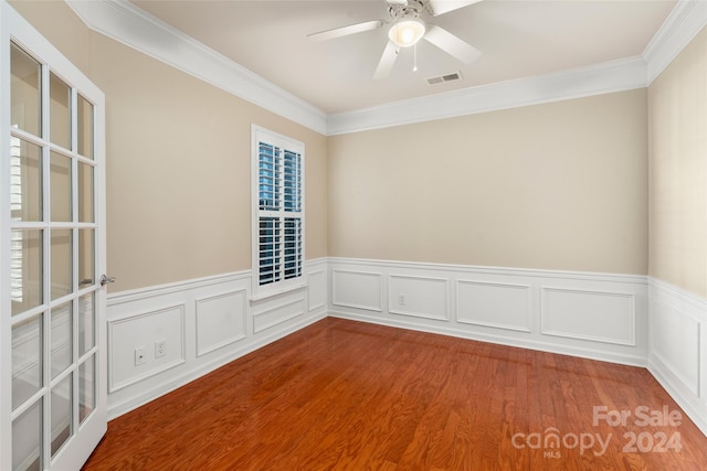 unfurnished room featuring hardwood / wood-style floors, crown molding, and ceiling fan