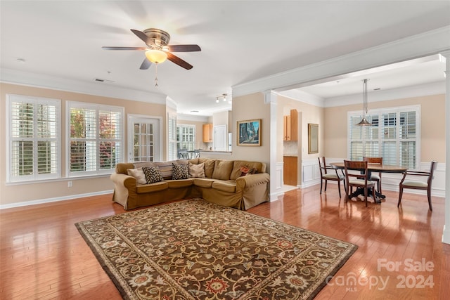 living room featuring ornamental molding, decorative columns, hardwood / wood-style flooring, and ceiling fan