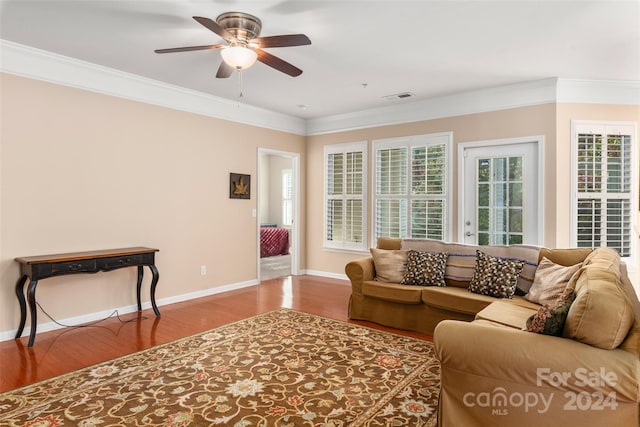 living room with ornamental molding, hardwood / wood-style flooring, and ceiling fan