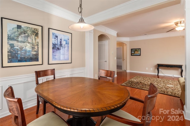 dining space with crown molding, hardwood / wood-style floors, and ceiling fan