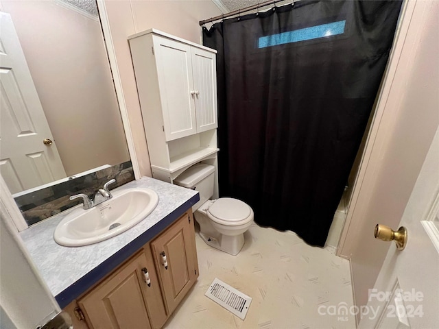 bathroom featuring vanity, crown molding, toilet, and a shower with shower curtain