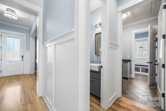 corridor featuring sink and crown molding