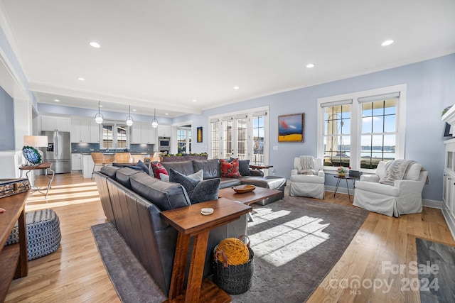 living room featuring light hardwood / wood-style flooring and ornamental molding