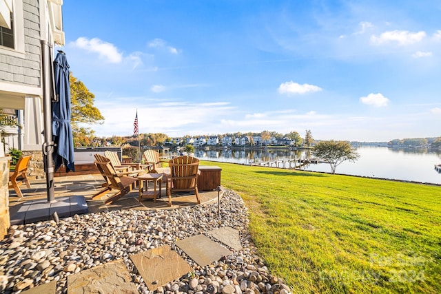 view of yard featuring a water view and a patio area