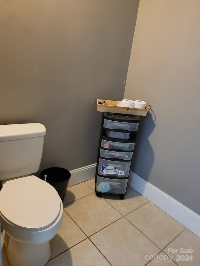 bathroom featuring toilet and tile patterned flooring