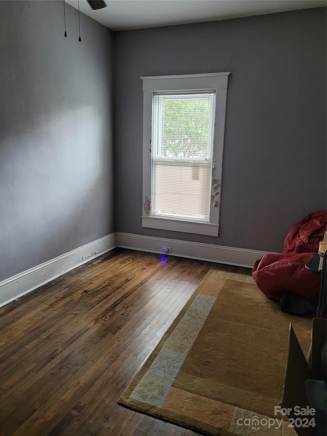 empty room featuring ceiling fan and dark hardwood / wood-style floors