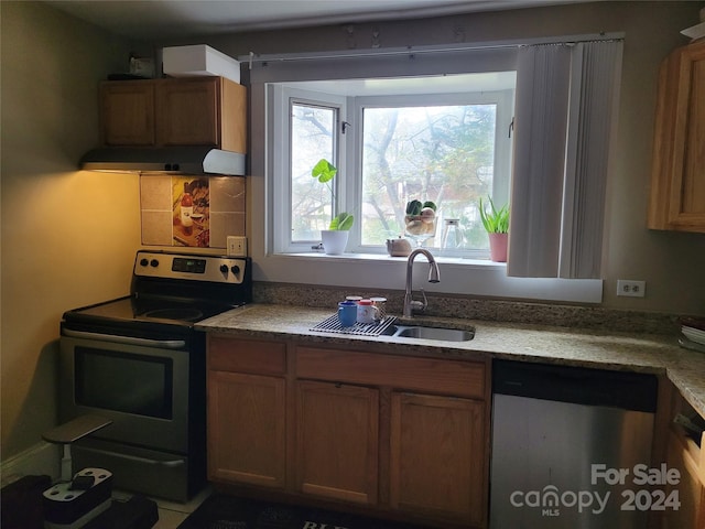 kitchen with ventilation hood, sink, and appliances with stainless steel finishes