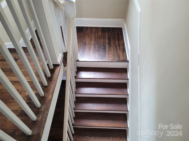 stairway featuring wood-type flooring