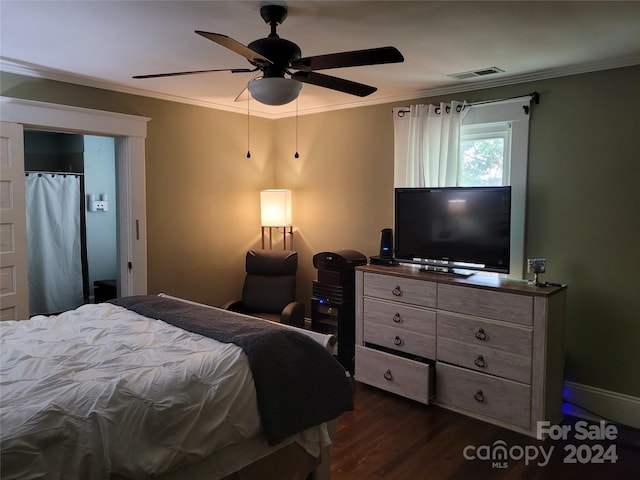 bedroom featuring dark wood-type flooring, ceiling fan, and ornamental molding