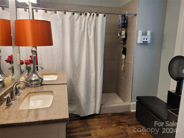 bathroom with curtained shower, wood-type flooring, and vanity