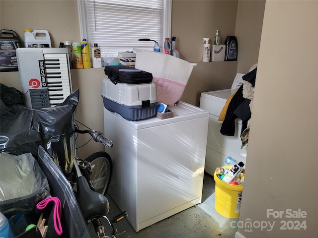 clothes washing area with washer and clothes dryer