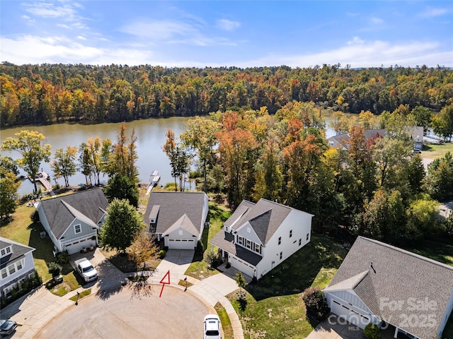 drone / aerial view with a water view and a view of trees