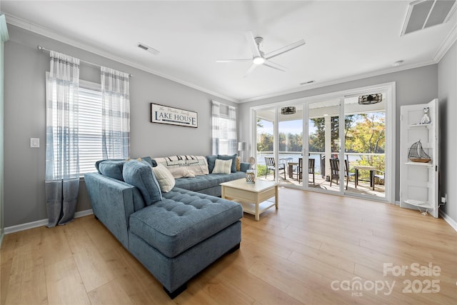 living room with ornamental molding, light wood-style flooring, and visible vents