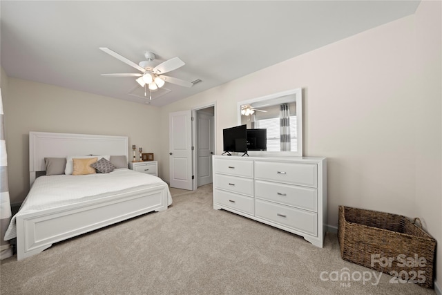 bedroom with a ceiling fan and light carpet