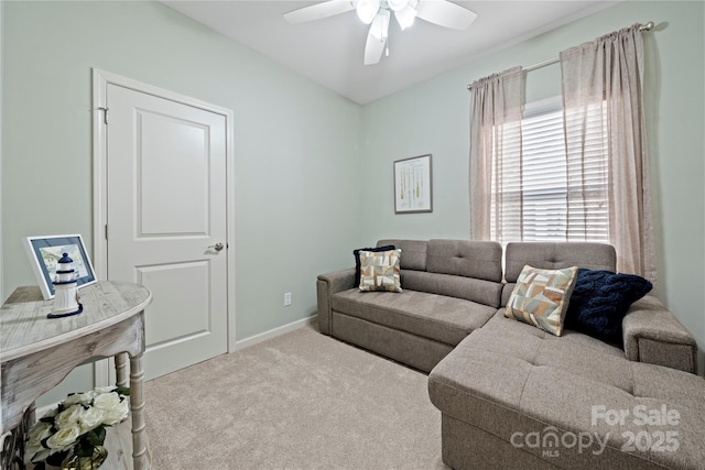 carpeted living area featuring a ceiling fan and baseboards