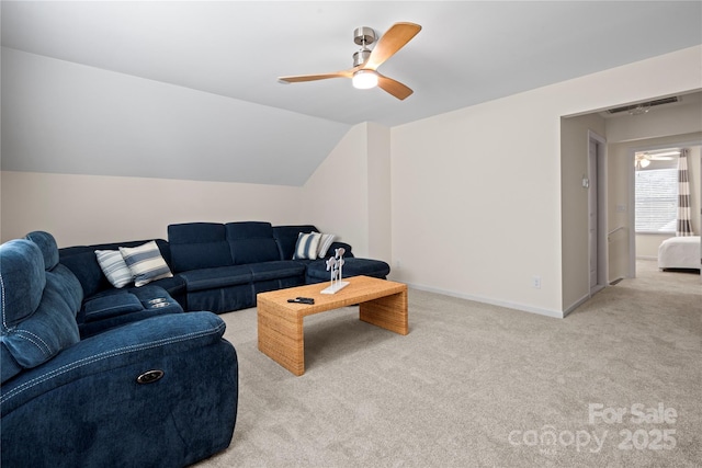 living area with carpet, lofted ceiling, visible vents, a ceiling fan, and baseboards