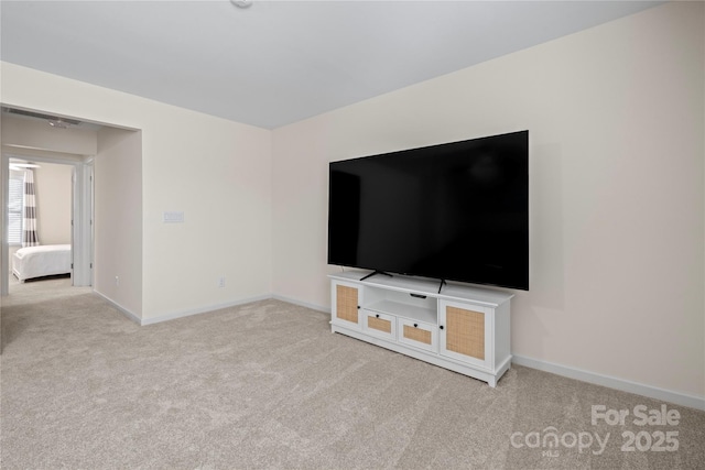 unfurnished living room featuring carpet flooring and baseboards