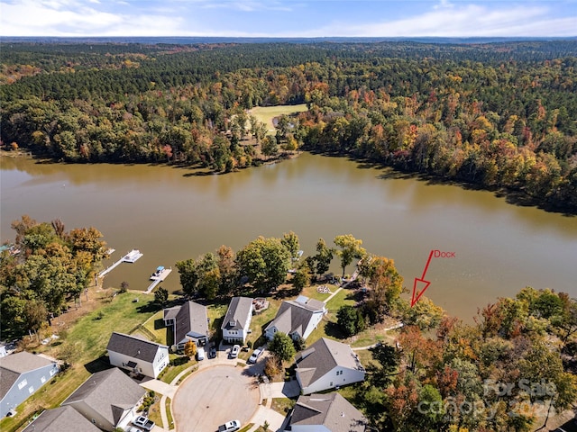 bird's eye view with a water view, a residential view, and a view of trees