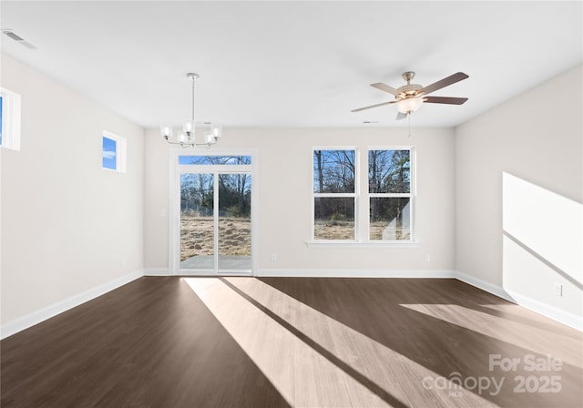 unfurnished room with dark wood-type flooring and ceiling fan with notable chandelier