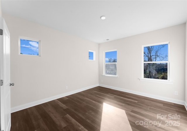 spare room with dark hardwood / wood-style floors