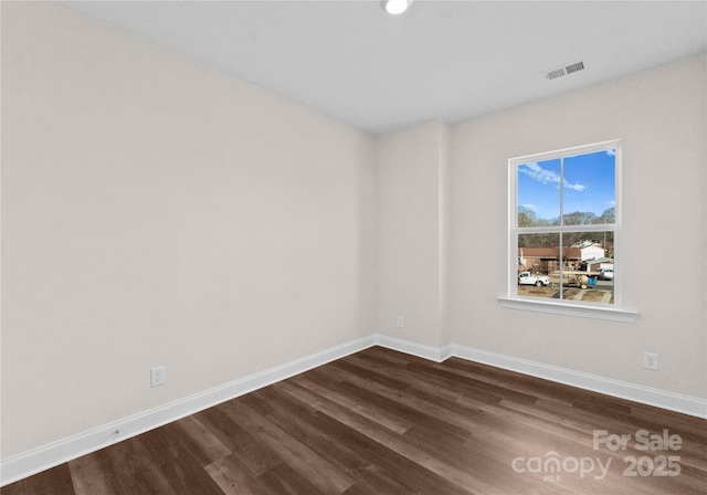 spare room with dark wood-type flooring