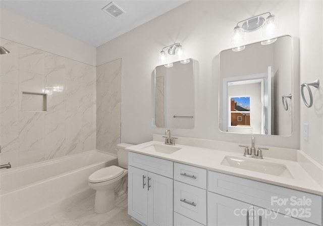 full bathroom with vanity, tiled shower / bath combo, and toilet