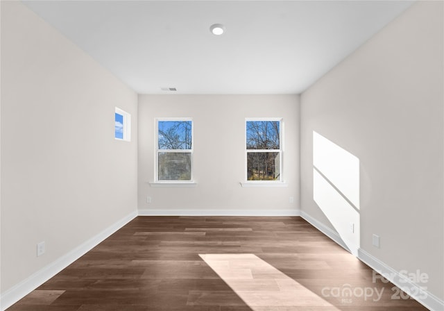 spare room with dark hardwood / wood-style flooring