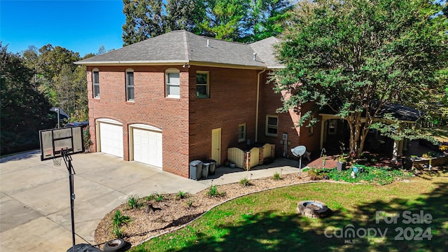 view of property exterior with a yard and a garage