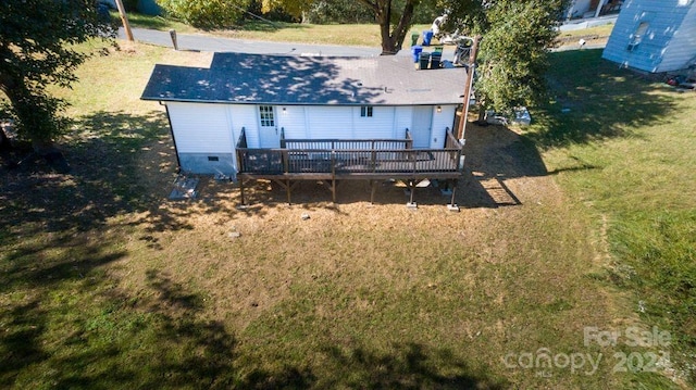 back of house featuring a yard and a wooden deck