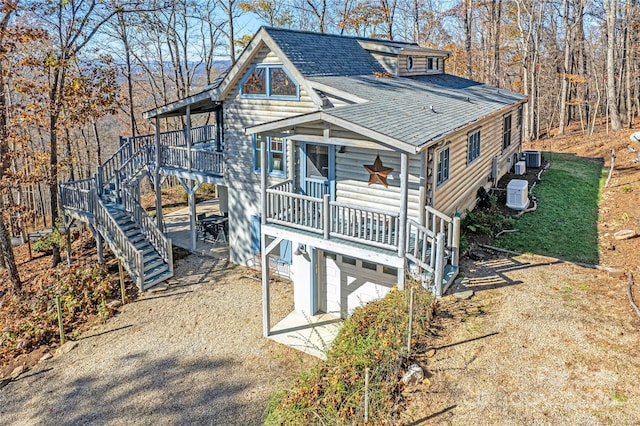 126 Bradley Ascent Ct, Hendersonville, NC 28792 - rustic home with stairway, a shingled roof, a garage, and central AC unit