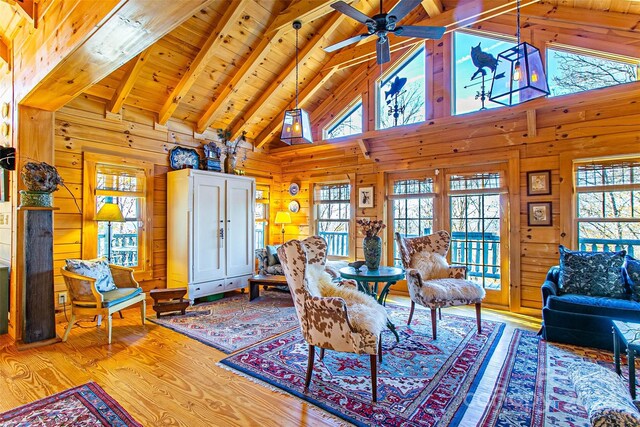 126 Bradley Ascent Ct, Hendersonville, NC 28792 - living room featuring beam ceiling, wood finished floors, ceiling fan, wooden walls, and wood ceiling