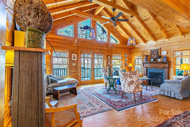 126 Bradley Ascent Ct, Hendersonville, NC 28792 - living room featuring high vaulted ceiling, a fireplace, wood walls, wood finished floors, and a ceiling fan