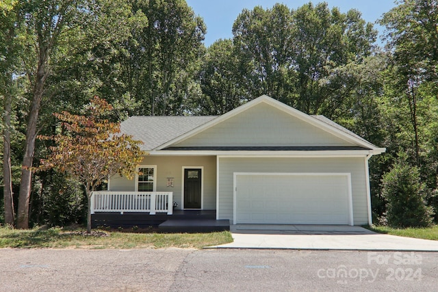 view of front of property featuring covered porch and a garage