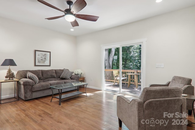 living room with light wood-type flooring and ceiling fan