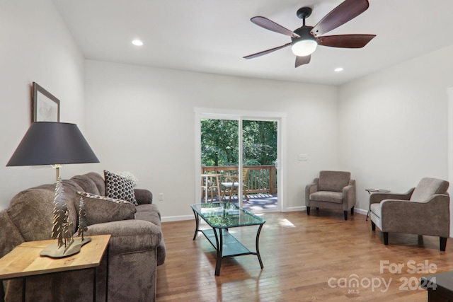 living room featuring ceiling fan and light wood-type flooring