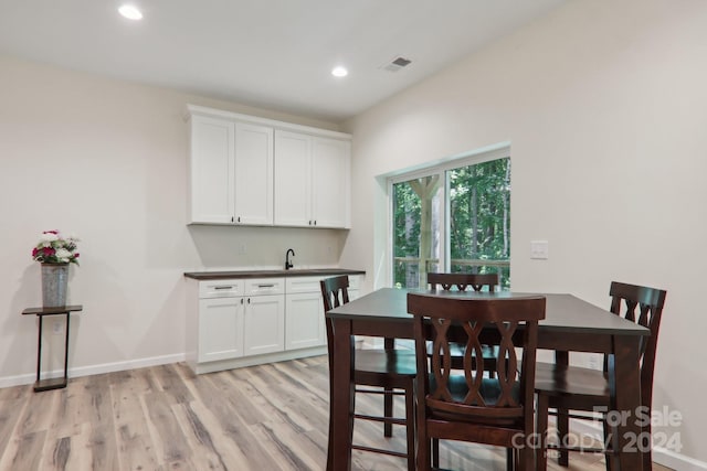 dining room featuring sink and light hardwood / wood-style flooring