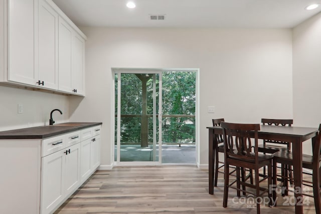 dining area featuring sink and light hardwood / wood-style floors