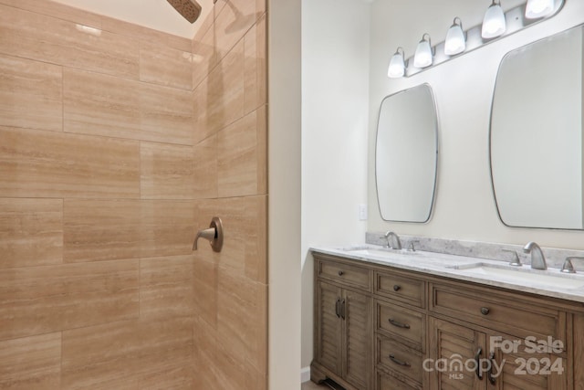 bathroom with vanity and tiled shower