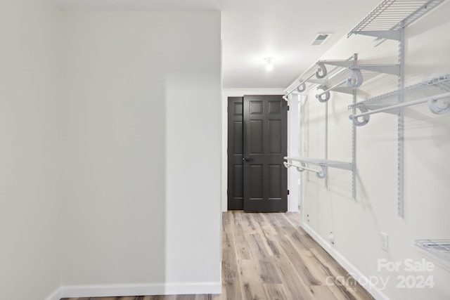 walk in closet featuring light hardwood / wood-style flooring