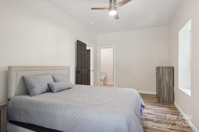 bedroom featuring ensuite bath, hardwood / wood-style floors, and ceiling fan