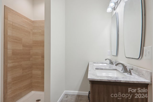 bathroom featuring vanity, tile patterned flooring, and walk in shower