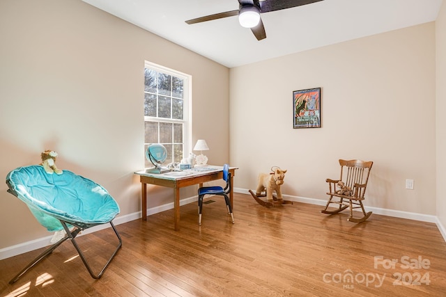 living area with ceiling fan and hardwood / wood-style flooring