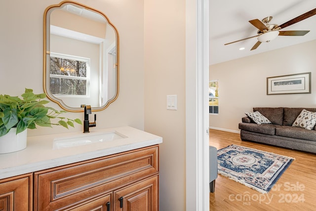 bathroom featuring ceiling fan, vanity, and hardwood / wood-style flooring