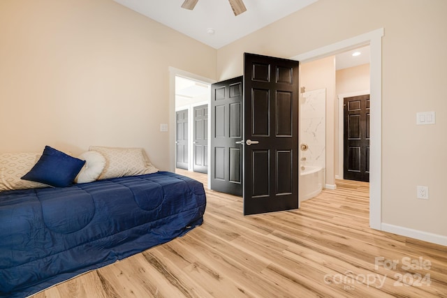 bedroom with light wood-type flooring, ensuite bathroom, and ceiling fan