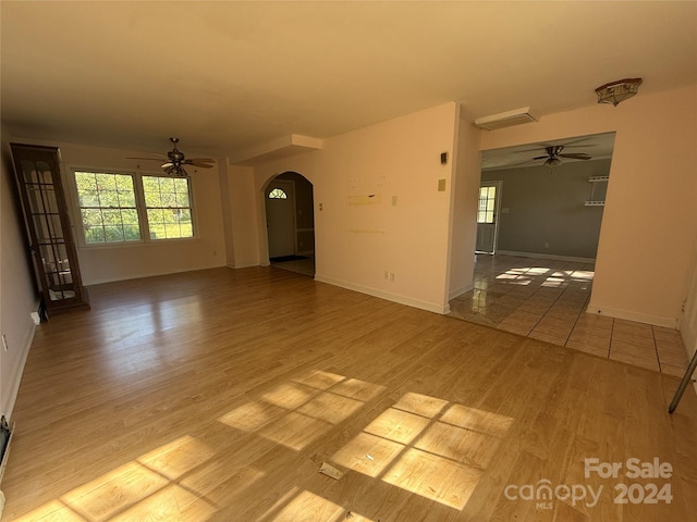 empty room with hardwood / wood-style floors and ceiling fan