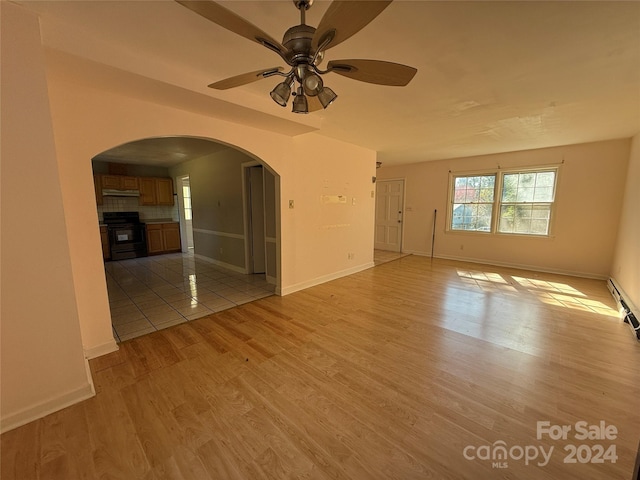 spare room featuring light hardwood / wood-style floors and ceiling fan