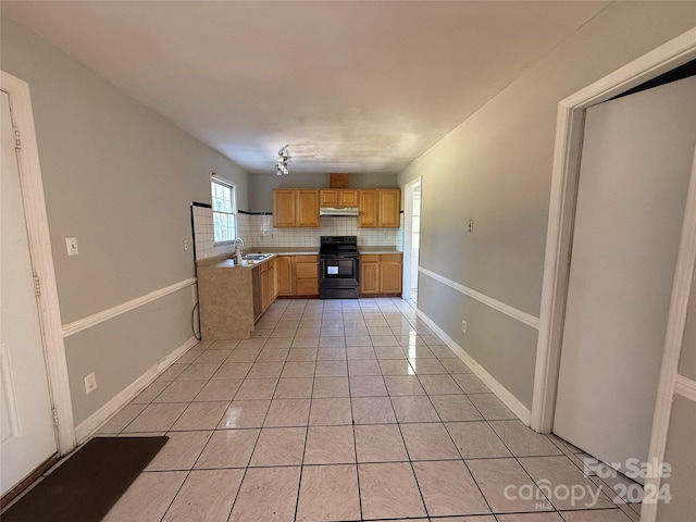 kitchen featuring sink, black electric range oven, backsplash, and light tile patterned floors