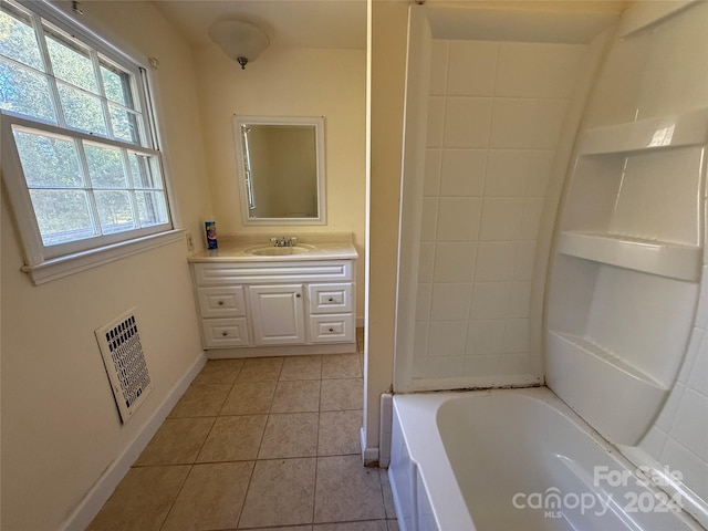 bathroom with vanity, tile patterned floors, and a bathing tub